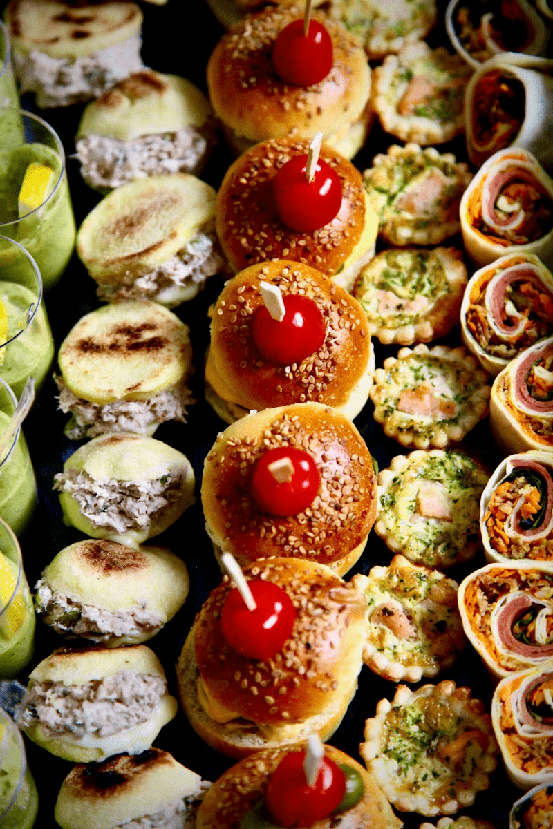 Gourmet catering appetizers with mini burgers and savory party finger foods